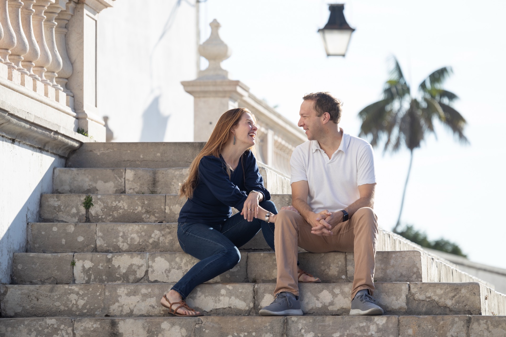 Danielle and Rich laughing together on steps
